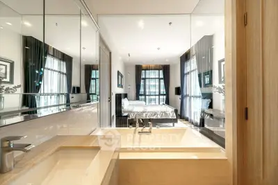Luxurious modern bathroom with bathtub and view into elegant bedroom