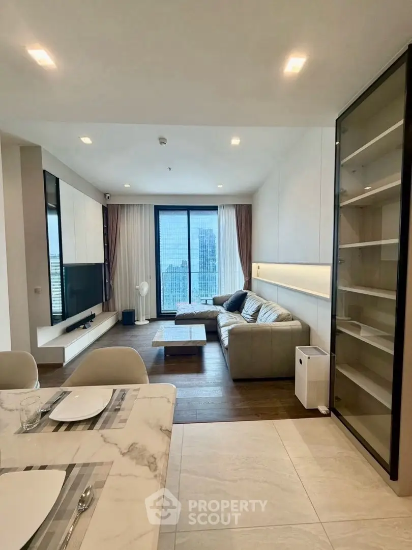 Modern living room with city view, featuring sleek furniture and open layout for stylish urban living.