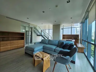 Spacious modern living room with large windows and stylish furniture