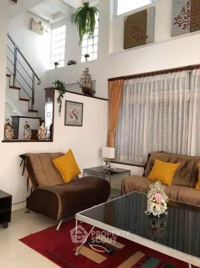 Charming living room with cozy seating, elegant decor, and natural light, perfect for relaxation and entertaining.