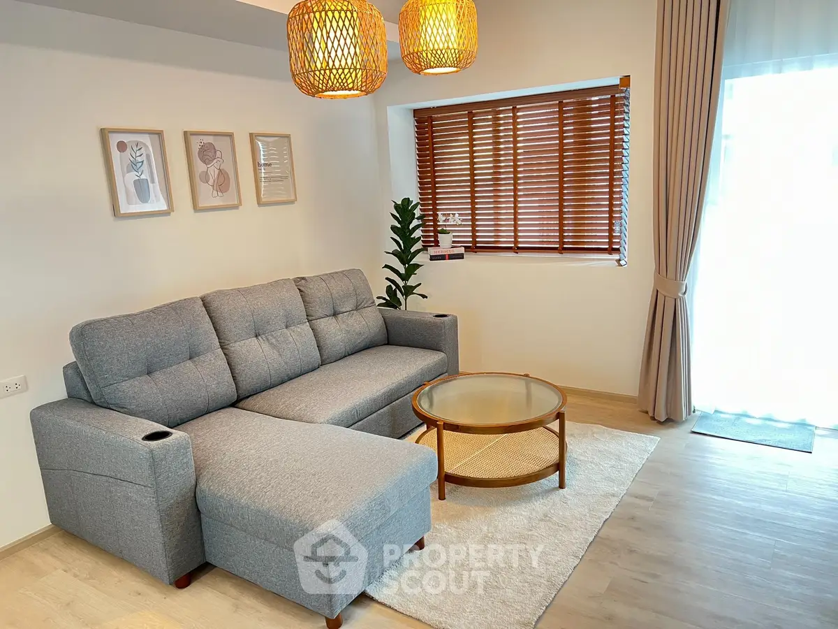 Modern living room with stylish gray sofa and warm lighting