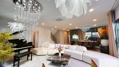 Luxurious living room with grand piano and elegant chandelier lighting