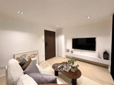 Modern living room with stylish decor and wall-mounted TV, perfect for relaxation.