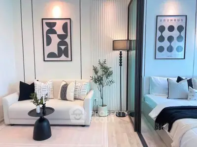 Modern living room with stylish decor and adjacent cozy bedroom in open layout apartment.