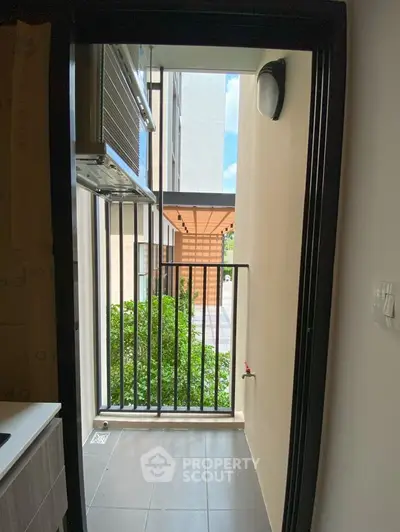 Charming small balcony with modern railing and lush greenery view