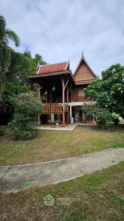 Charming traditional wooden house with lush garden and unique architectural design.