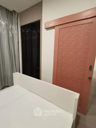 Modern bedroom with stylish pink sliding door and elegant curtains