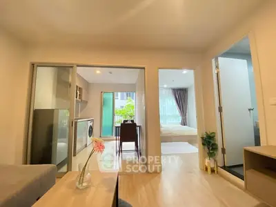 Modern apartment interior with open layout, featuring living room, kitchen, and bedroom with natural light.