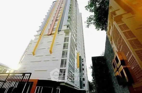 Modern high-rise building with unique architectural design and vibrant accents.