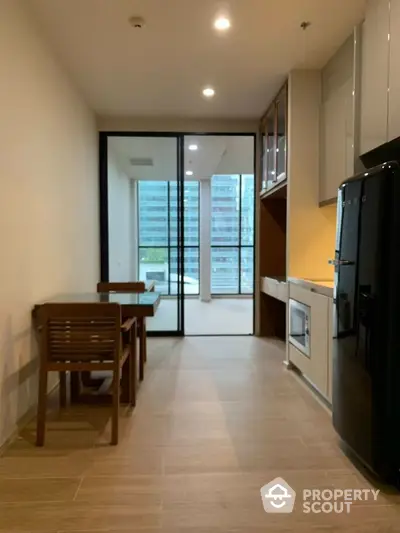 Modern kitchen with sleek appliances and dining area in a stylish apartment