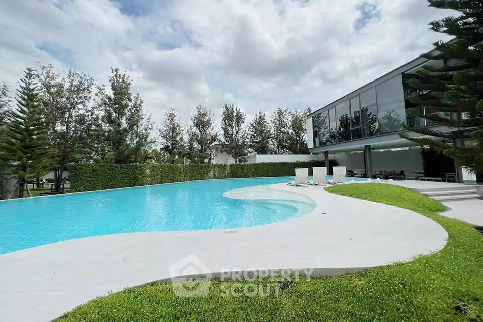 Luxurious modern home with stunning pool and lush greenery