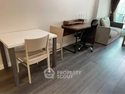 Modern living room with sleek furniture and wooden flooring, ideal for urban living.