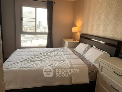 Cozy bedroom with elegant decor and city view from window.