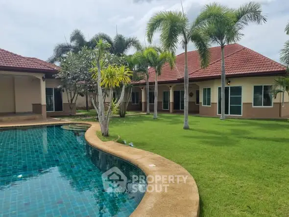 Luxurious villa with a stunning pool and lush garden, perfect for tropical living.