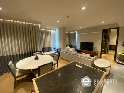 Spacious and modern living area with elegant marble dining table, plush seating, and sophisticated neutral decor, perfect for entertaining and relaxation.