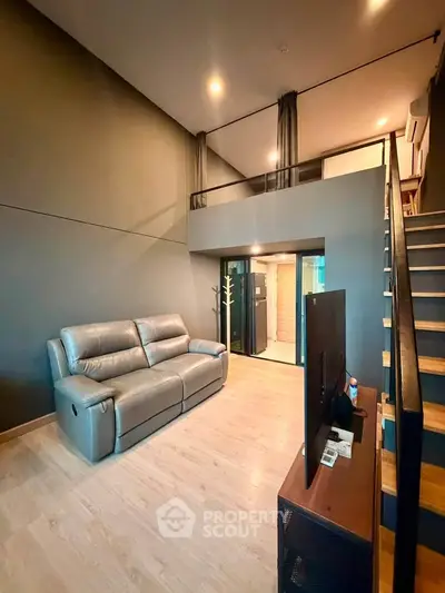 Modern loft-style living room with sleek design and cozy ambiance