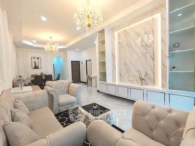 Luxurious living room with elegant chandeliers and marble accents