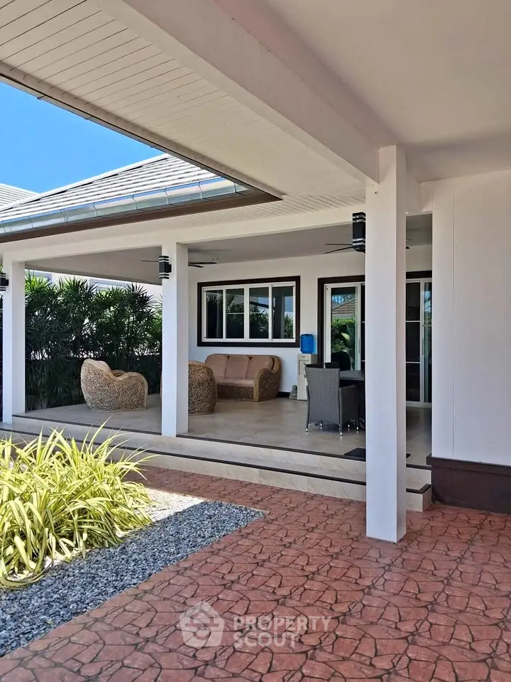 Luxurious patio with stylish outdoor furniture and lush greenery, perfect for relaxation and entertaining.