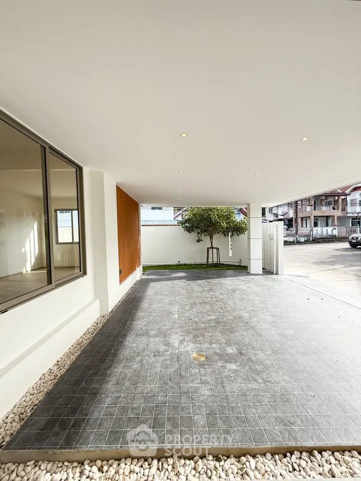 Spacious modern carport with sleek design and natural stone accents