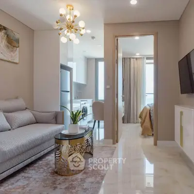 Modern living room with elegant decor and open kitchen layout in a stylish apartment.