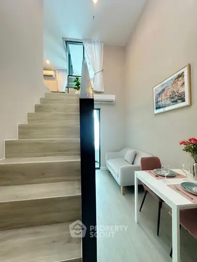Modern loft apartment with stylish staircase and cozy dining area