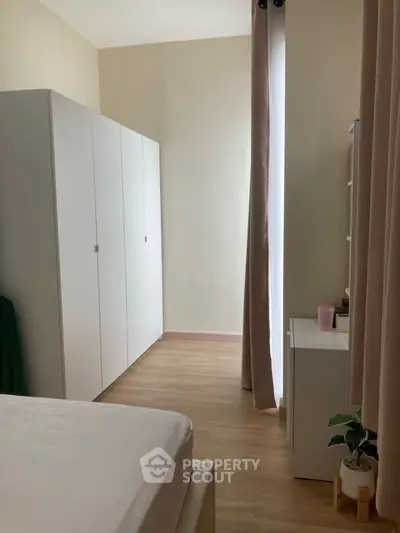 Cozy bedroom with minimalist decor and ample natural light