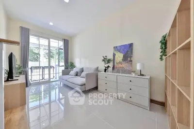 Spacious living room with modern decor and large windows offering natural light.