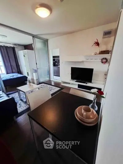 Modern studio apartment with open layout, featuring a cozy living area and stylish kitchen.