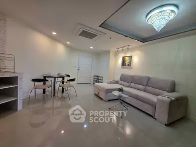 Modern living room with elegant chandelier and cozy sofa