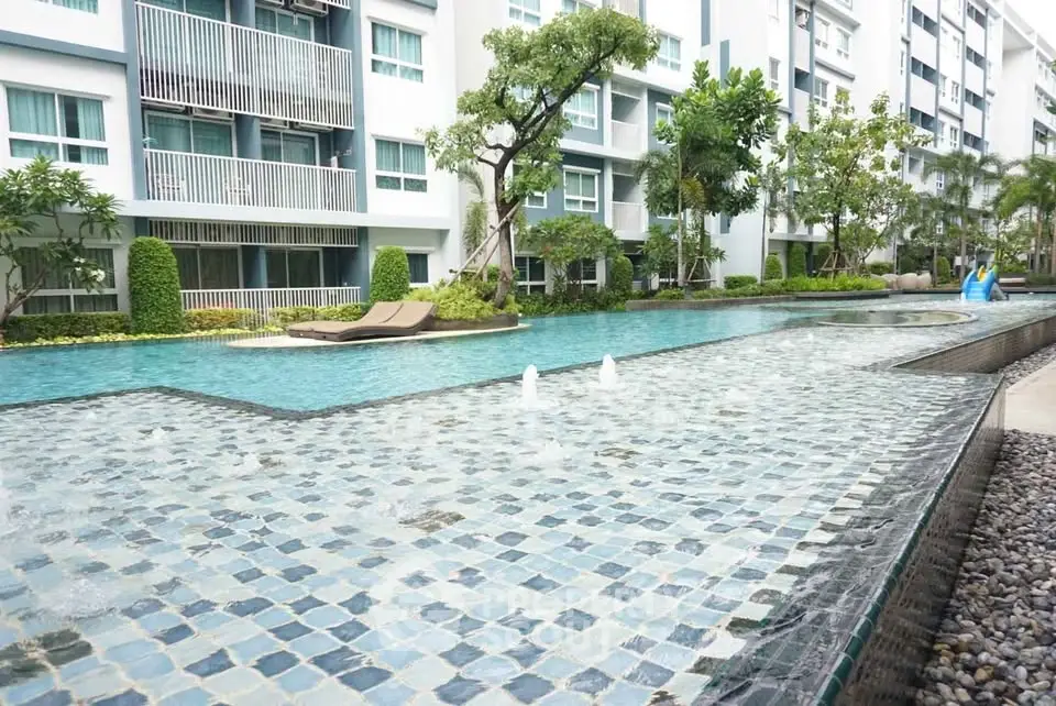 Luxurious condominium with stunning pool and lush garden view.