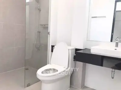 Modern bathroom with glass shower and sleek fixtures