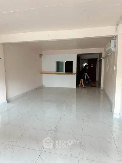 Spacious empty living room with marble flooring and air conditioning