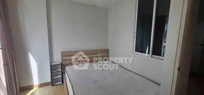Minimalist bedroom with natural light and wooden flooring