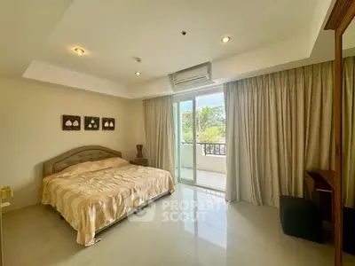 Spacious bedroom with balcony access and serene view in modern apartment