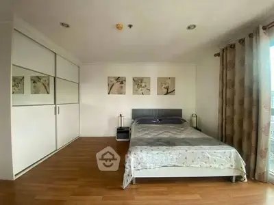 Spacious bedroom with modern decor and large wardrobe