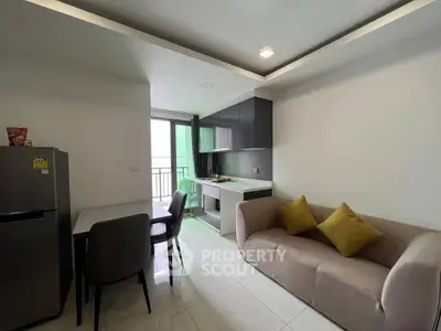 Modern open-layout kitchen and living area with sleek design and balcony access.