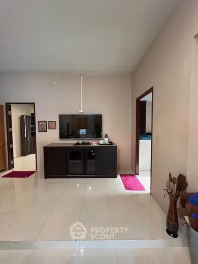 Spacious living room with modern TV setup and elegant decor