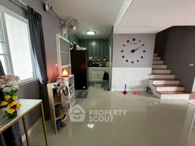 Spacious living area with modern decor and staircase in a stylish home