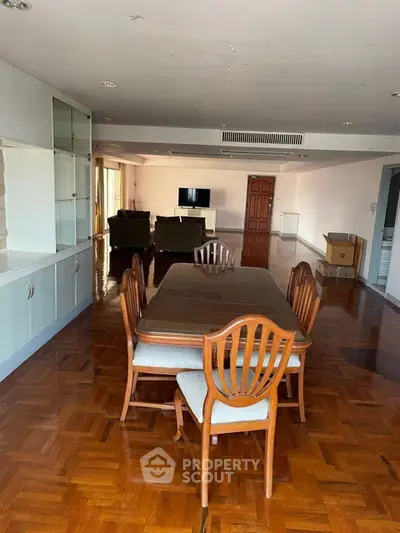 Spacious living room with elegant dining area and cozy seating, perfect for family gatherings.