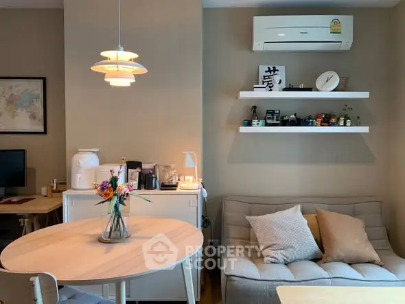 Cozy living room with modern decor and air conditioning, perfect for relaxation.