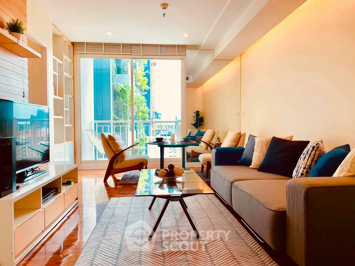 Spacious modern living room with stylish decor and large windows offering natural light and city views.