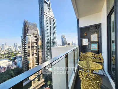 Luxurious balcony with ornate furniture and stunning city view in high-rise building.