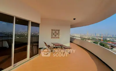 Spacious balcony with stunning city skyline view, perfect for relaxation and entertainment.