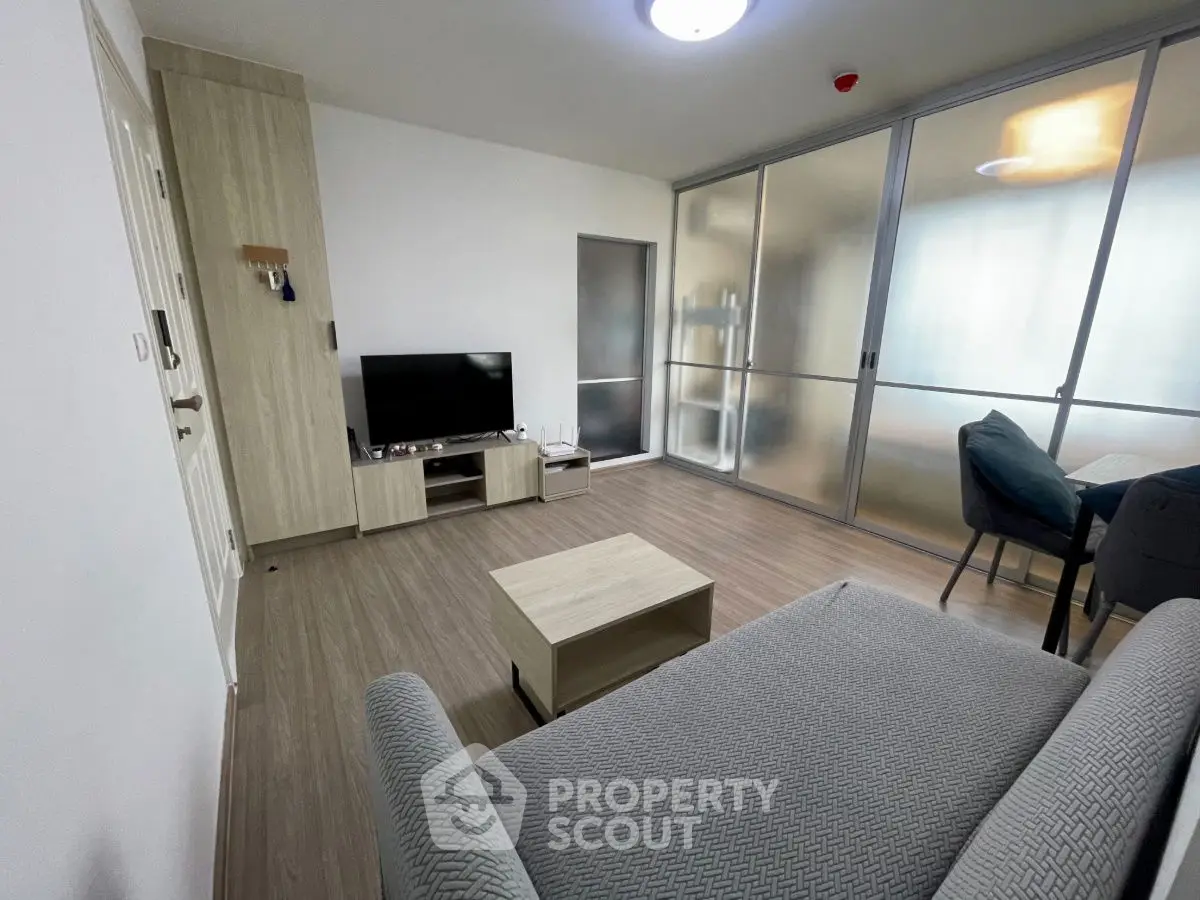 Modern living room with sleek furniture and frosted glass sliding doors