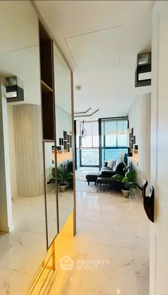 Luxurious modern living room with marble flooring and stylish decor, featuring a cozy seating area and large windows.