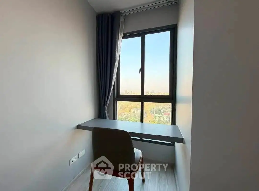 Cozy study nook with a stunning city view, perfect for work or relaxation.