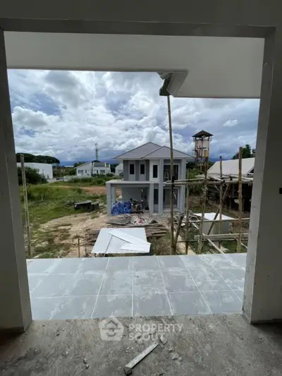 Modern house under construction with scenic view and spacious balcony.