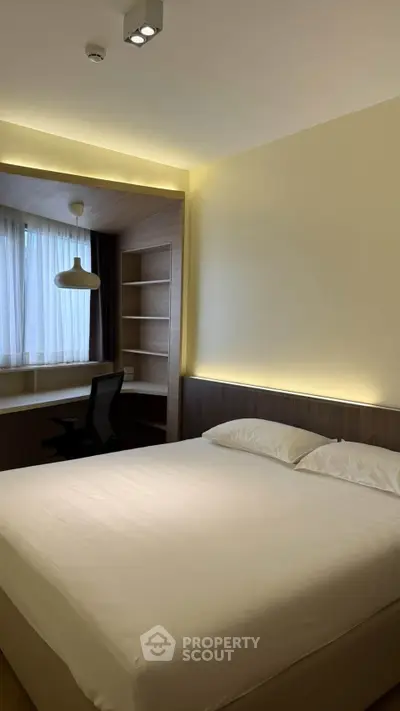 Modern bedroom with built-in study area and ambient lighting