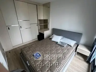 Modern bedroom with stylish bed and built-in wardrobe in a cozy apartment.