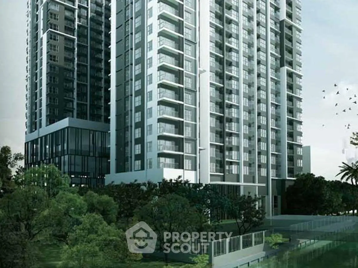 Modern high-rise residential building with lush green surroundings and sleek architectural design.